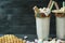 Banana milkshake with ice cream and whipped cream, marshmallows, cookies, waffles, served in a glass cup decorated with