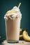Banana Milkshakes with whipped cream topping and straw and banana