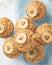 Banana muffin, top view, close up, vertical. Morning breakfast on blue napkin, white concrete table