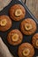 Banana muffin  in tray, top view, vertical. Cupcakes on old linen napkin, rustic wooden table, a breakfast with cake