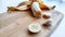 Banana with open panel and sliced round pieces on wooden board and white background. Ripe banana with peel Close up and