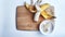 Banana with open panel on wooden board and sliced round pieces on the plate on white background. Ripe banana with peel