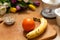 banana, orange and seeds vivid smoothie ingredients and blender, juicer, tulips on the background