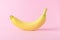 Banana on pink background. Minimal style. Flat lay.