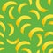 Banana seamless pattern on green background. Tropical fruits wallpaper.