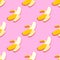 Banana seamless pattern in paper cut style. Origami yelllow tropical fruit on pink.