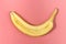 Banana sliced on pastel pink background