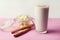 Banana smothie or milkshake with cinnamon on pink  background