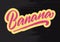 Banana sticker on black wood background