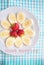 Banana and strawberries on a white plate inscription good morning