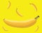 Banana surrounded with floating smaller bananas with yellow background.