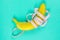 Banana with tape for measuring figure. Centimeter ruler spinned around fruit. Tape wrapped around banana isolated on mint