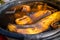 Banana tincture in water for watering plants, close-up. Plastic bucket with water and banana peel