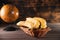 Bananas in a basket on a wooden brown natural background near a brown globe