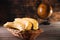 Bananas in a basket on a wooden brown natural background near a brown globe