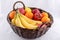 Bananas, Oranges, Apples, and Lemons in a wicker basket