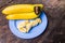 Bananas ripen, yellow background, serving as a wood desk.