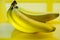 Bananas on a string, yellow background