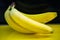 Bananas on a string, yellow background, funny bananas with eyes, background