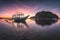 Banca boat at Corong Corong beach on low tide shallow water in twilight lit by sunset light, El Nido, Palawan