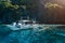 Banca local boat on turquoise water against huge limestone cliffs. Island hopping tour trip. Exploring Philippines