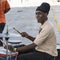 Band member of steel band playing in front of cruiser in Barbados