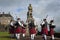 Band of pipers playing in front of the statue of Robert the Bruce in the Stirling Castle in Stirling, Scotland