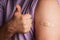 bandage on a mans arm after scratch on skin or injection for vaccine. A medical patch or plaster on a male shoulder after