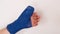Bandaged hand.Blue surgical bandage on the arm on a white background.Broken arm. Fractures and sprains. Bandages and
