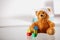 Bandaged Teddy Bear with Block Shapes on the Table