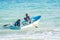 Bandar Siraf, Iran - May 20, 2017. Father and son sail for fishing in Persian Gulf in small blue boat with fishermens nets