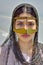 Bandari woman wears a traditional mask, beach of Persian Gulf.