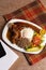 Bandeja paisa traditional dish in medellin with pork rice egg banana lemon tomato avocado and red beans