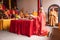 Bandung, Indonesia - January 8, 2022 : The Monks with orange clothes pray together in front of the altar