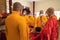 Bandung, Indonesia - January 8, 2022 : The Monks with orange clothes pray together in front of the altar