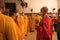 Bandung, Indonesia - January 8, 2022 : The Monks with orange clothes pray together in front of the altar