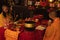 Bandung, Indonesia - January 8, 2022 : The monks sitting on the chair while praying on the altar in orange costumes