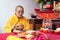 Bandung, Indonesia - January 8, 2022 : The monks sitting on the chair while praying on the altar in orange costumes