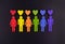 Baner of the LGBT community. Little people in the colors of the flag of the LGBT community on a black background. The concept of e