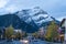 Banff Avenue in autumn and winter season night. Snow Capped Cascade Mountain in the background.