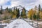 Banff Pedestrian Bridge and Bow River trail in snowy autumn day.