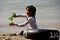 Bang Saen, Thailand: Little Girl Playing in Sand