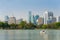 Bangkok cityscape and paddle boat in a lake of Lumphini public park. Public park in metropolitan. Paddle boat pier