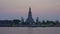 BANGKOK - FEBRUARY 3 : Timelapse of Wat Arun temple at sunset with boat traffic in Chao Phraya river in Thailand