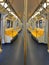 Bangkok skytrain has yellow symmetrical seats