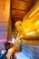 BANGKOK, THAILAND - 2.11.2019: Tourist are taking photo of big statue of lying Buddha in Wat Pho temple, Bangkok. Large golden