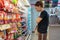 BANGKOK, THAILAND - DECEMBER 16, 2018: Unidentified customer shops for packaged sausages in 7-Eleven convenient store on