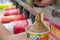 BANGKOK, THAILAND - DECEMBER 18: Slurpee machine fills up a paper cup with Coca-Cola flavored Slurpee in 7-Eleven on Petchkasem 69