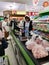 BANGKOK, THAILAND - DECEMBER 31: Unidentified asian female cashier with santa hat scanning grocery items at supermarket on