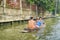 BANGKOK, THAILAND - FEBRUARY 09, 2018: Outdoor view of unidentified people paddling in a small boat sailing at yai canal